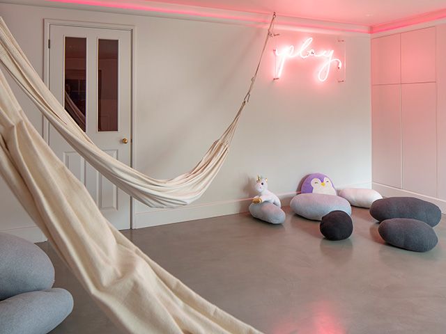 childrens playroom with neon sign - home tour - goodhomesmagazine.com