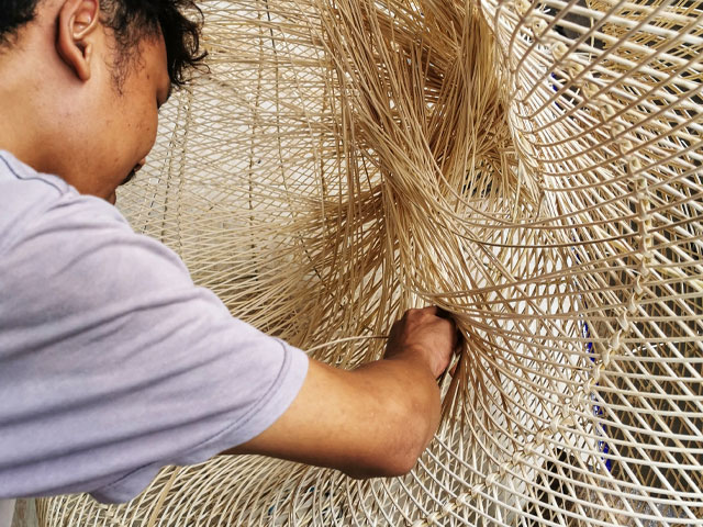 rattan being handwoven in Indonesia for Collectiviste lampshades