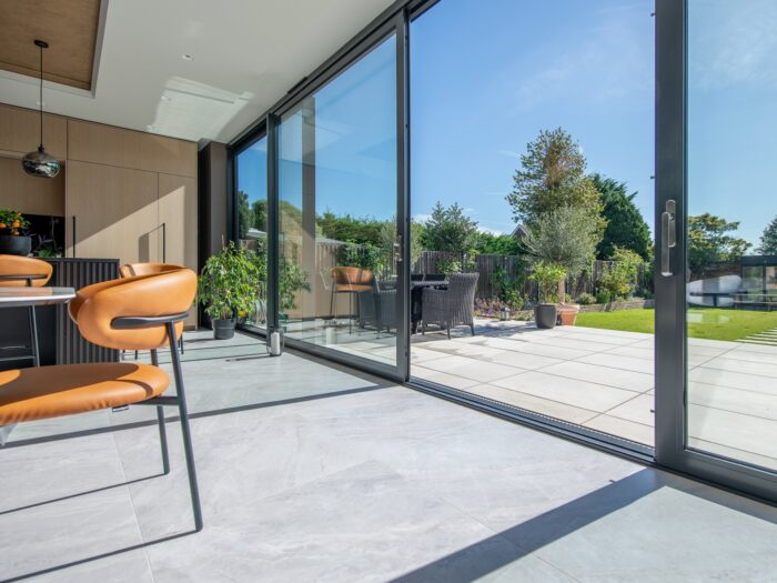 Large aluminium sliding door system in kitchen looking out to garden