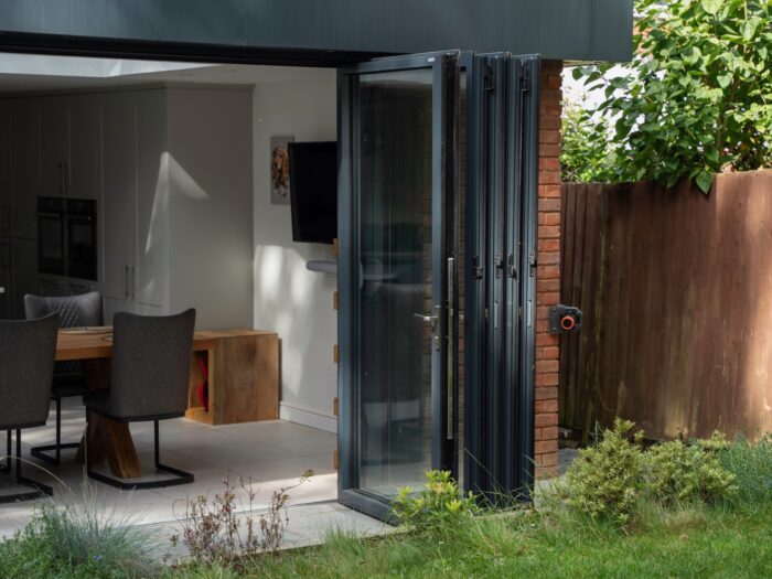 Opened bi-fold doors in concertina with study area beyond