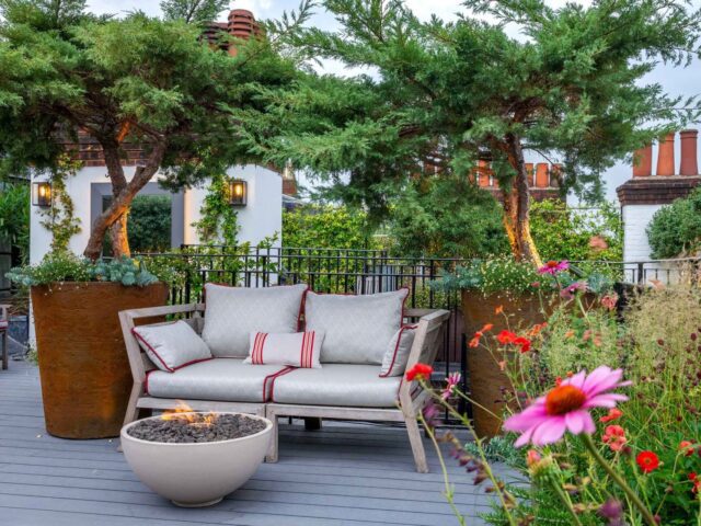 Rooftop garden with grey composite deck and garden bench