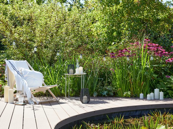 Curved garden deck with pond and deck chair