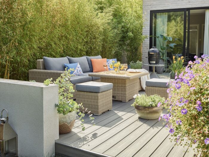 Decked area with outdoor corner sofa and stool