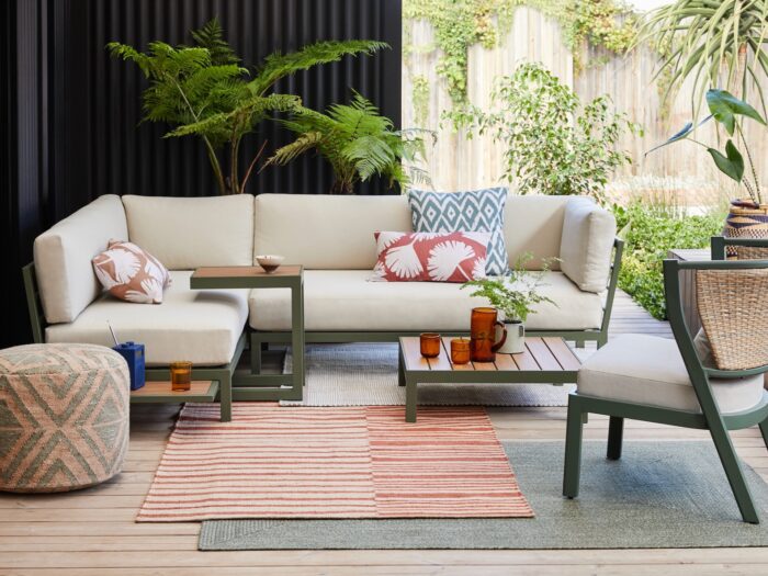 Decked outdoor area with outdoor sofa and rugs