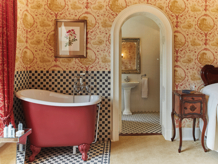 Make a bijoux tiled space for a bath in a bedroom