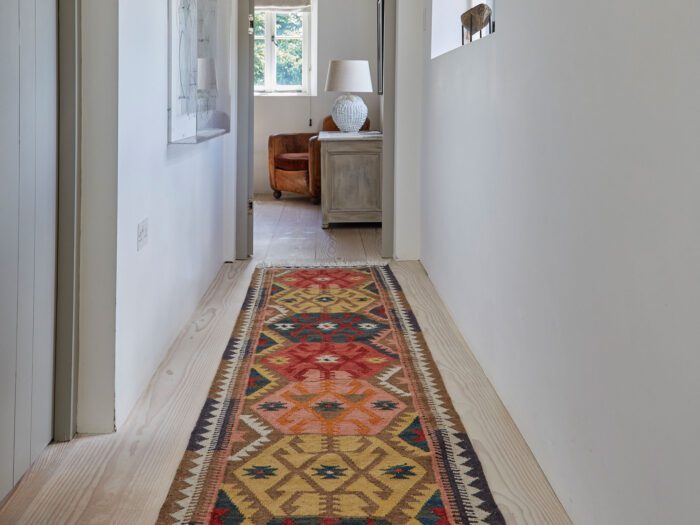 Don't overlook the hallways as a room, when thinking of how to add the right rug to your interiors