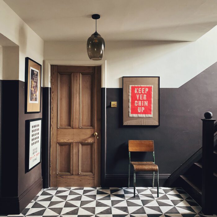 Chocolate walls work brilliantly with the stripped door and black and white tiles in this hall