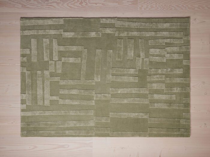 A textured sage green rug