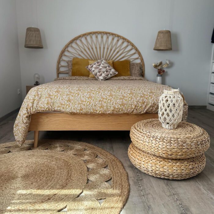 A bedroom with a round jute rug