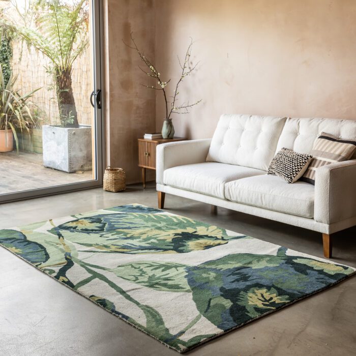 A living room with a large rug featuring a botanical print