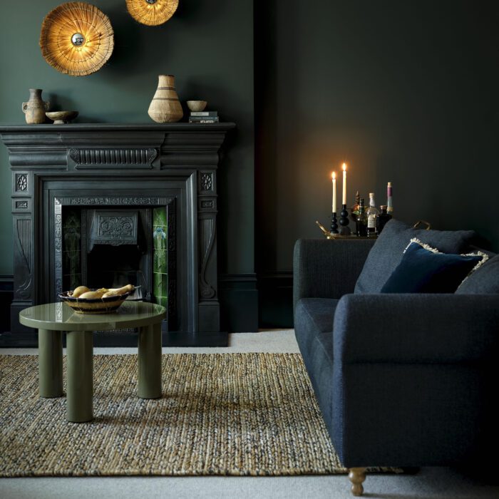 A living room with a jute rug on the floor