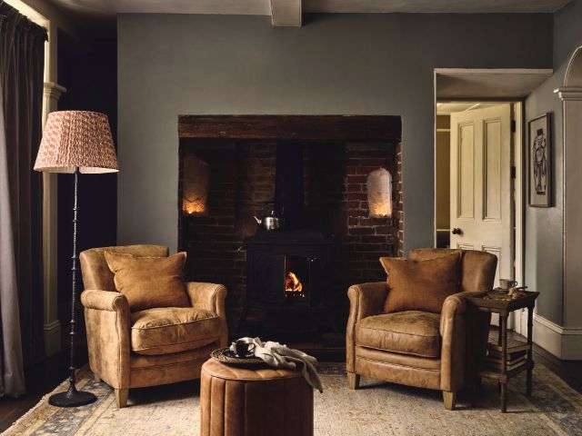 Living room with leather armchairs masculine in style