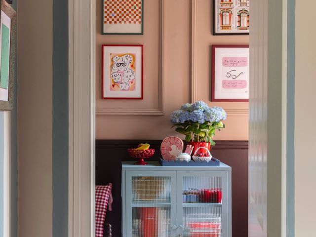 blue cabinet with striped wallpaper