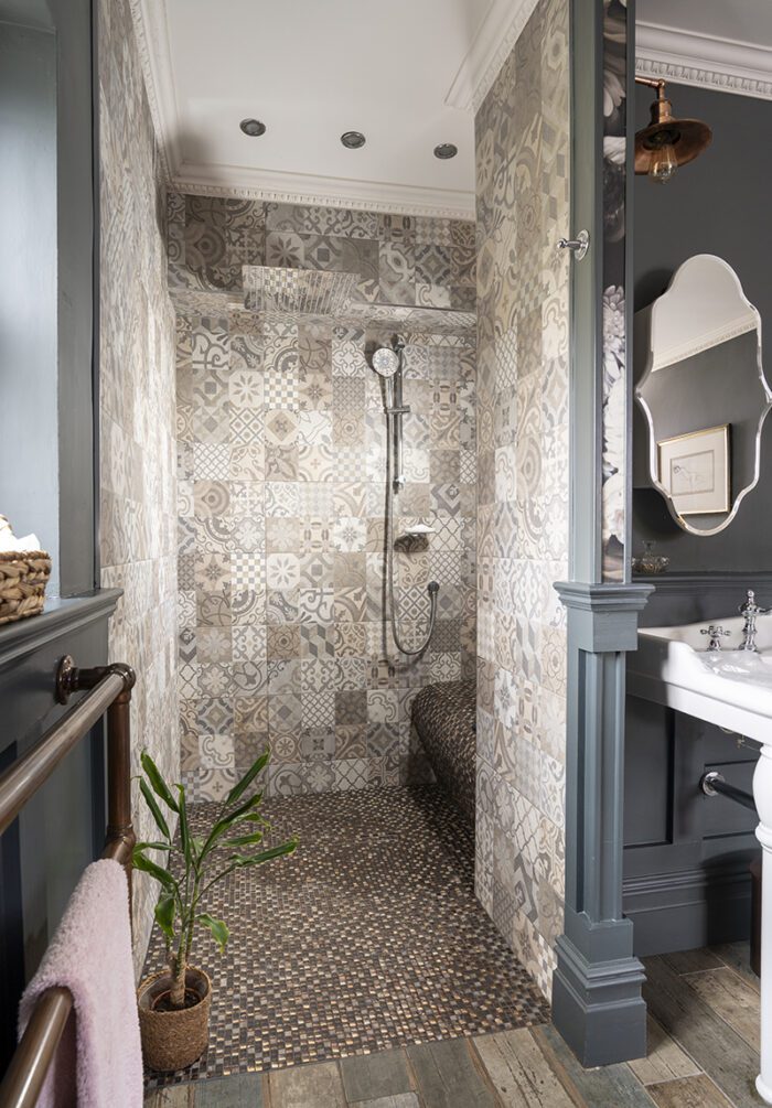 SIDE BY SIDE 
Building out a wall for a walk-in shower also meant creating an alcove which was the ideal spot for the vanity unit, with double sinks to beat the morning rush and matching wall lights and mirrors. 
